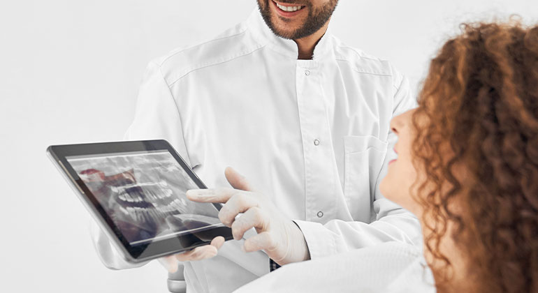 patient looking at dental x-ray